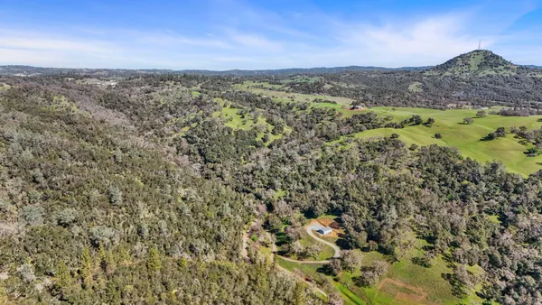 an aerial view of a house with a yard