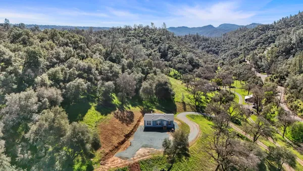 a kitchen with a sink a microwave and cabinets