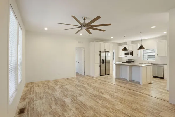 a kitchen with a sink stove and refrigerator