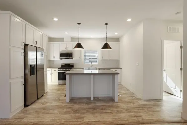 a view of small space with wooden floor and cabinet