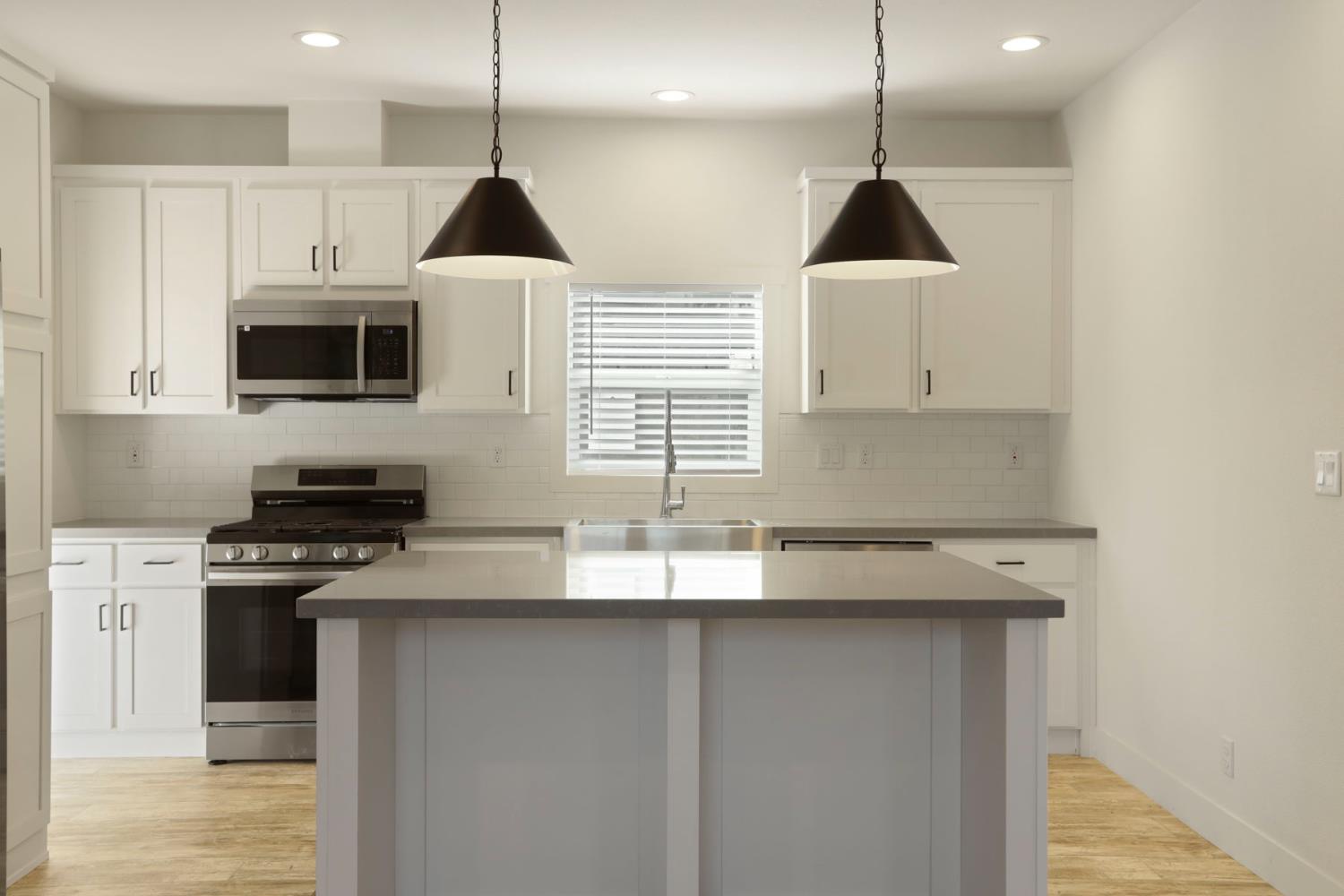 7680 Middle Bar Road Jackson, CA 95642 - Photo 22 of 58 a kitchen with a sink a microwave and cabinets