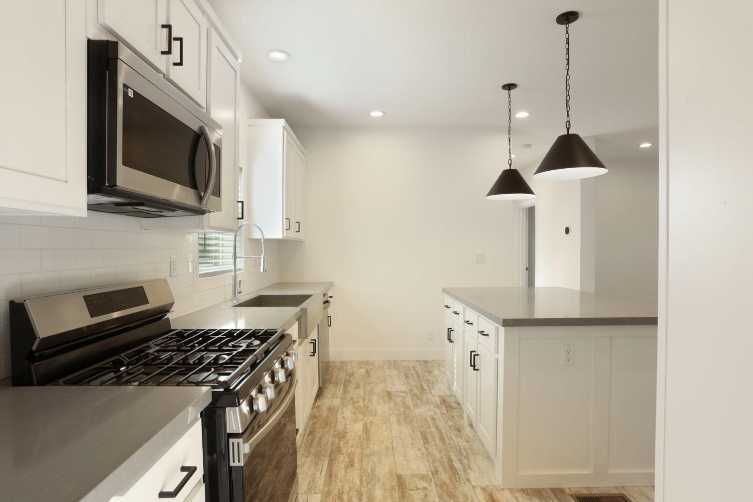 7680 Middle Bar Road Jackson, CA 95642 - Photo 25 of 58 a kitchen with stainless steel appliances a stove a microwave and a sink
