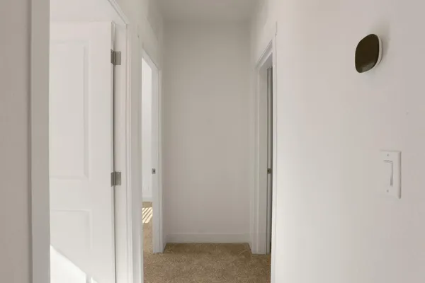 an empty room with closet and a bathroom