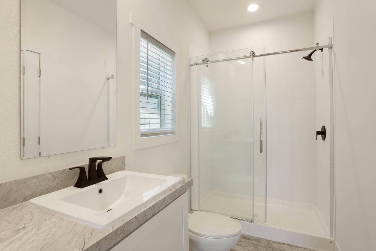 7680 Middle Bar Road Jackson, CA 95642 - Photo 39 of 58 a bathroom with a sink a toilet and shower