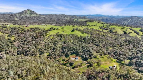 a view of a field with mountains in the background