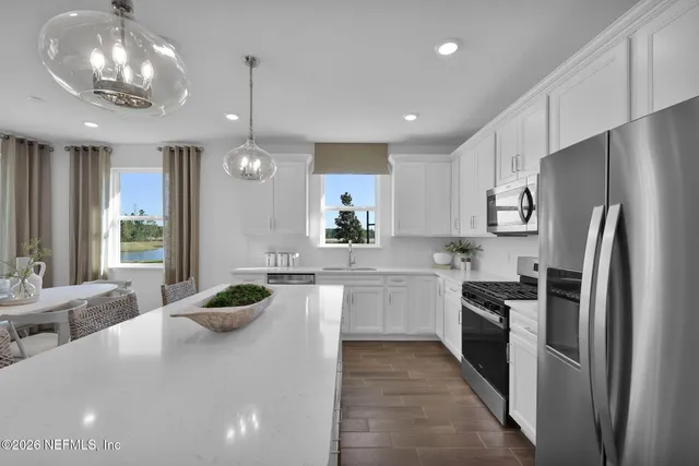 a living room with furniture potted plant and a chandelier