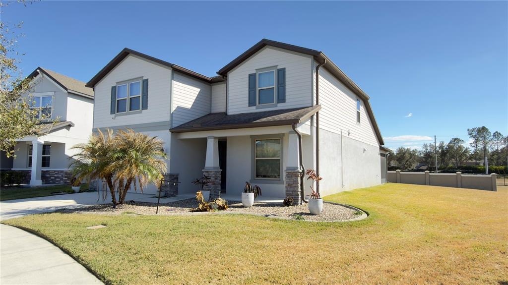 7360 Pool Compass Loop Wesley Chapel, FL 33545 - Photo 2 of 54 a view of a house with yard and plants