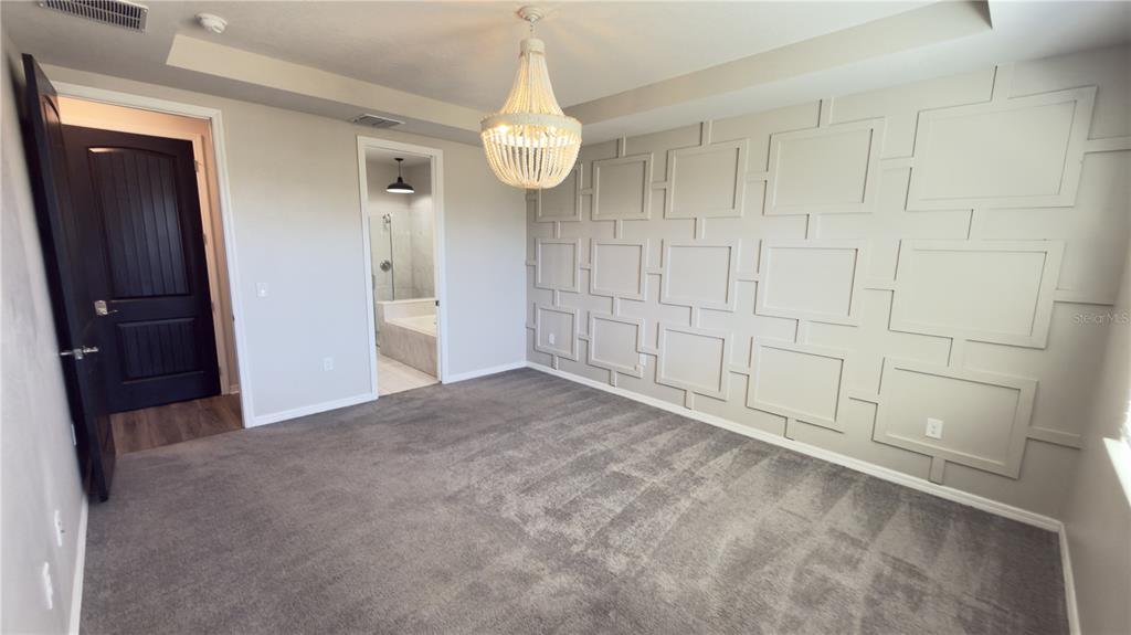 7360 Pool Compass Loop Wesley Chapel, FL 33545 - Photo 22 of 54 a view of an empty room with wooden floor