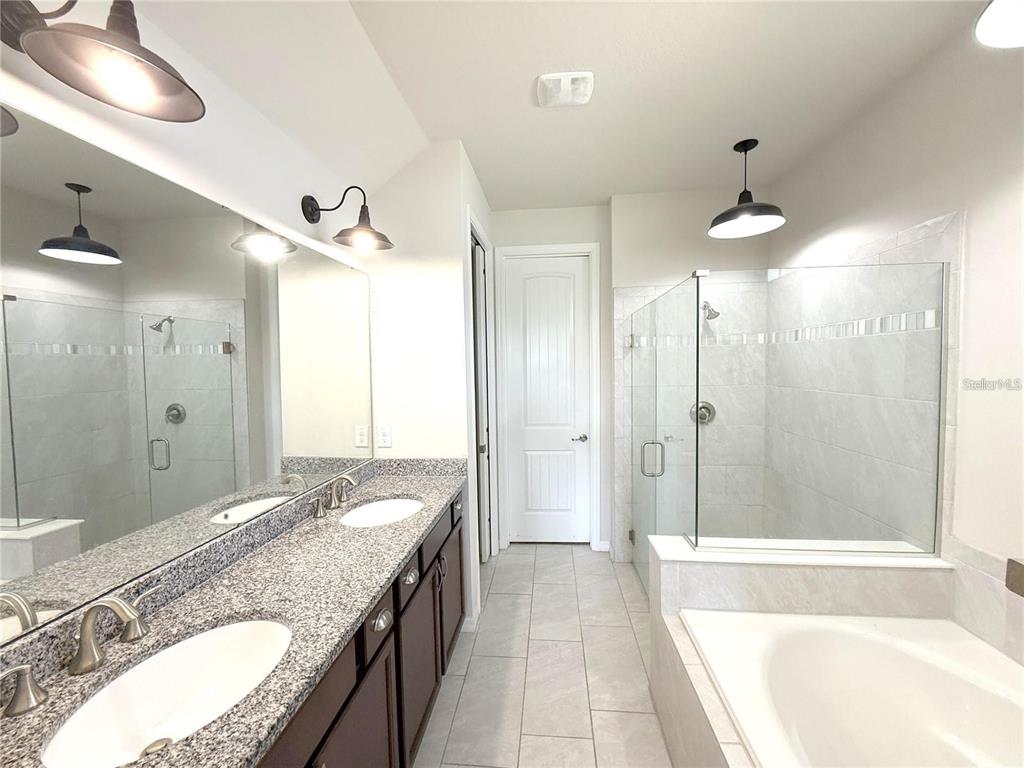7360 Pool Compass Loop Wesley Chapel, FL 33545 - Photo 29 of 54 a bathroom with a granite countertop double vanity sink and a mirror