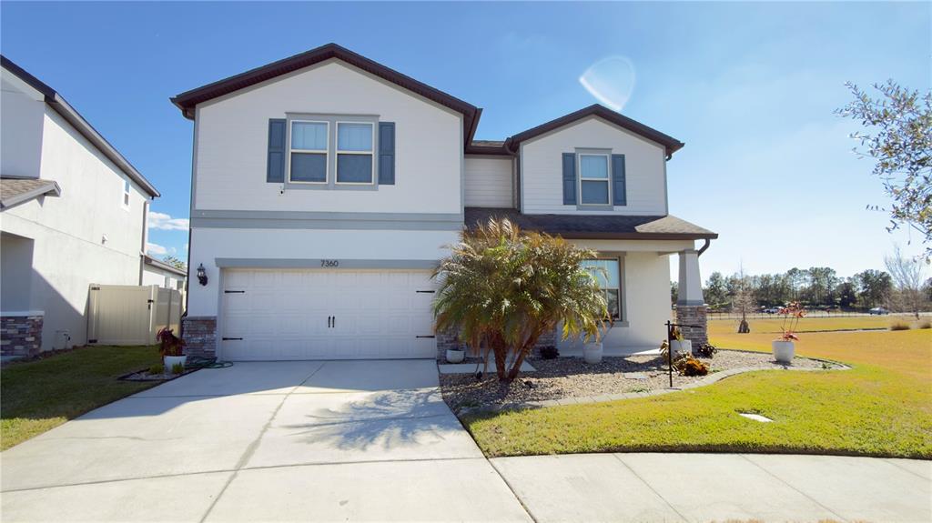 7360 Pool Compass Loop Wesley Chapel, FL 33545 - Photo 3 of 54 a view of house with garden space and sitting area