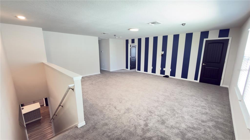 7360 Pool Compass Loop Wesley Chapel, FL 33545 - Photo 34 of 54 a view of a hallway with staircase