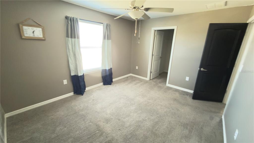 7360 Pool Compass Loop Wesley Chapel, FL 33545 - Photo 40 of 54 an empty room with windows and closet