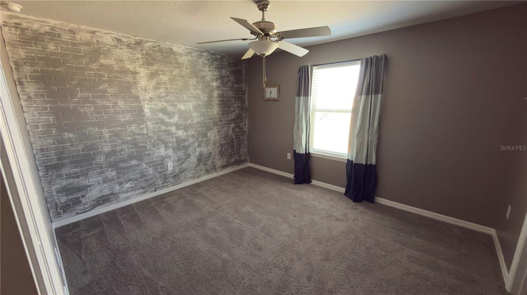 7360 Pool Compass Loop Wesley Chapel, FL 33545 - Photo 41 of 54 en empty room with windows and fan