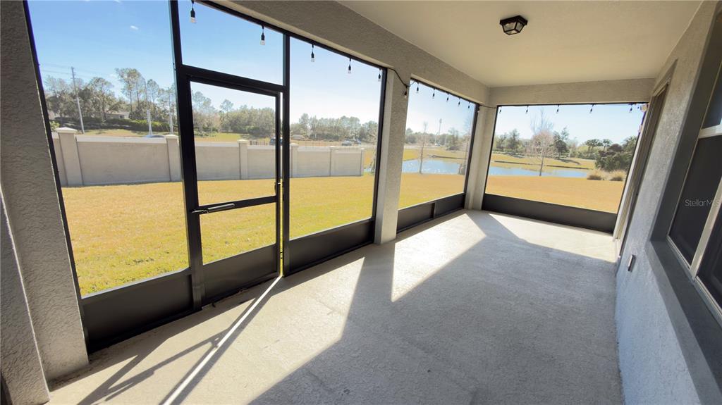 7360 Pool Compass Loop Wesley Chapel, FL 33545 - Photo 44 of 54 a view of an empty room with a large window