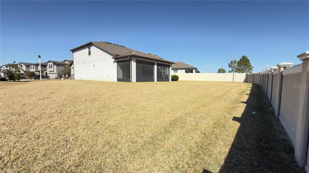 7360 Pool Compass Loop Wesley Chapel, FL 33545 - Photo 47 of 54 a big house with yard in front of it