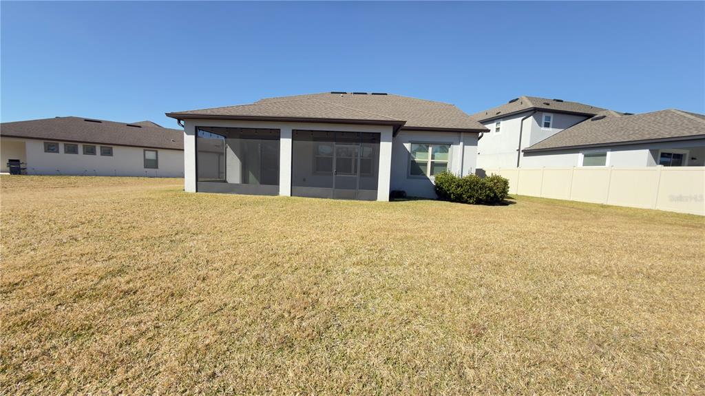 7360 Pool Compass Loop Wesley Chapel, FL 33545 - Photo 51 of 54 a front view of a house with a yard