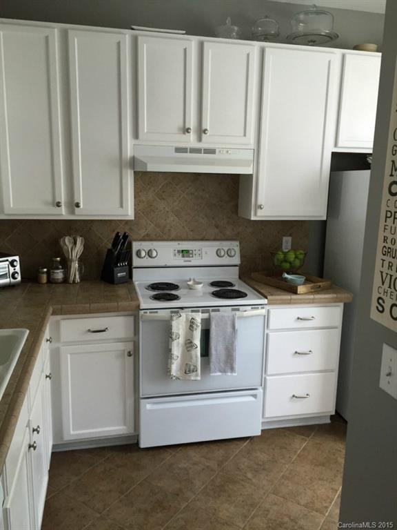 745 Shellstone Place, Unit 83 Fort Mill, SC 29708 - Photo 19 of 20 a kitchen with granite countertop white cabinets and stainless steel appliances