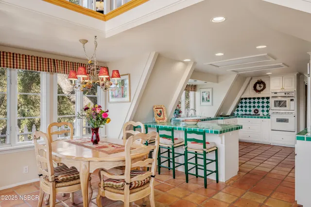 a view of kitchen with cabinets and window