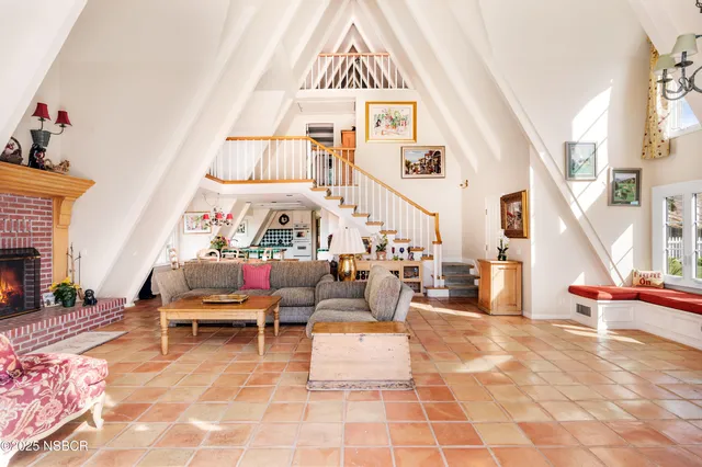 a living room with furniture a fireplace and a rug