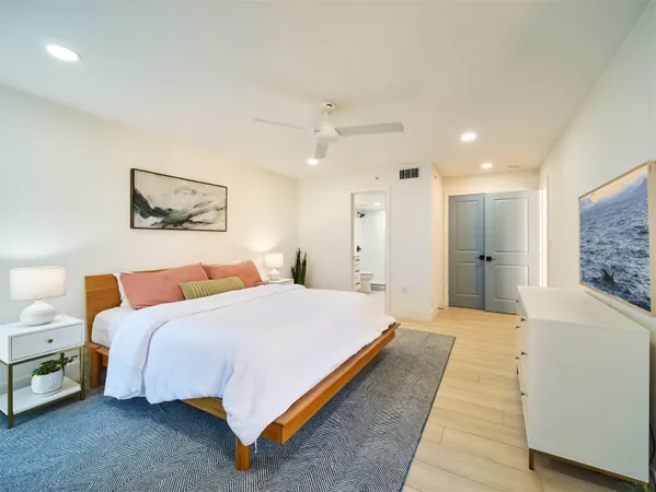 a spacious bedroom with a bed and a couch