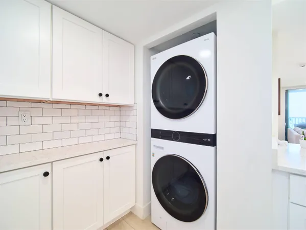 a close view of a utility room with dryer and washer