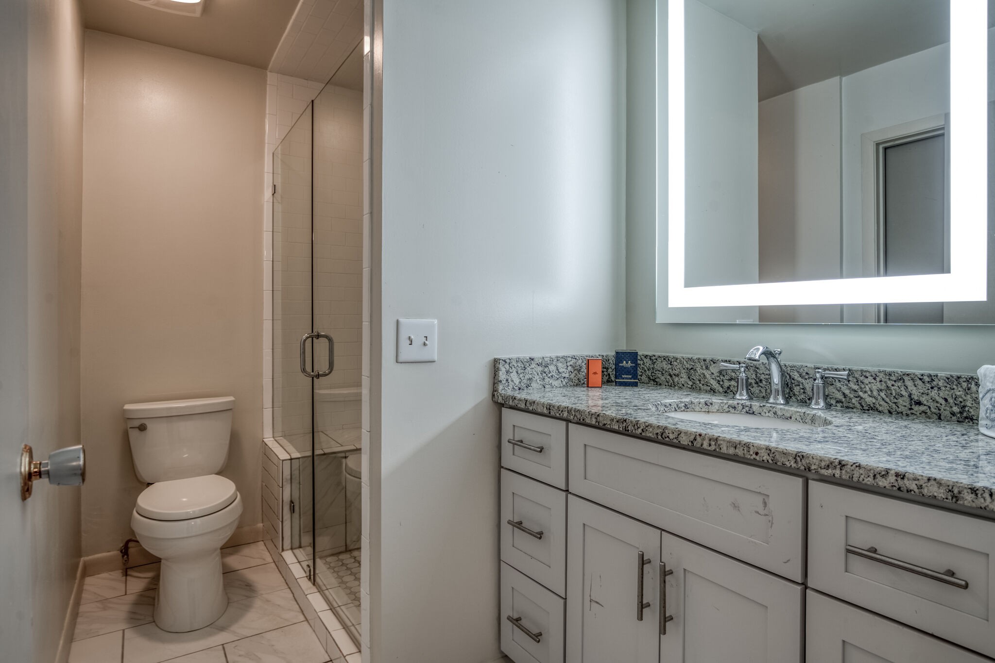 4134 West Hamilton Road Nashville, TN 37218 - Photo 24 of 35 a bathroom with a granite countertop toilet sink and mirror