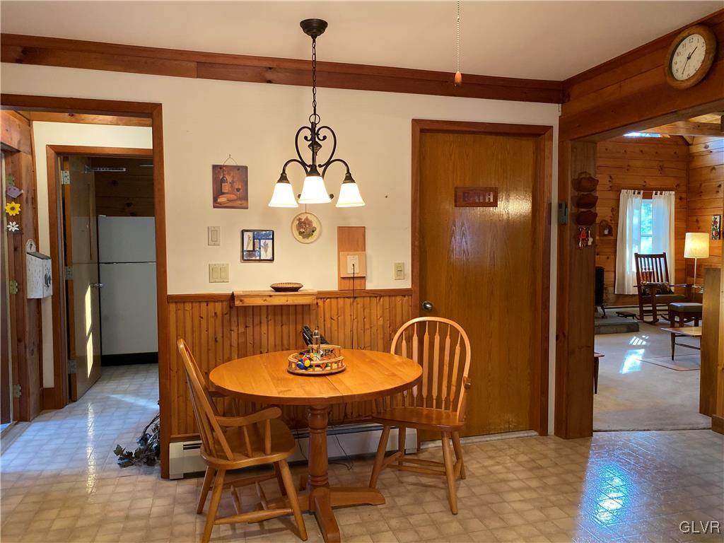 103 Antler Road Bartonsville, PA 18321 - Photo 7 of 32 a dining room with furniture a chandelier and wooden floor
