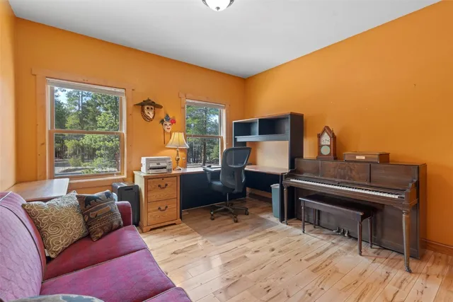 a living room with furniture and a piano