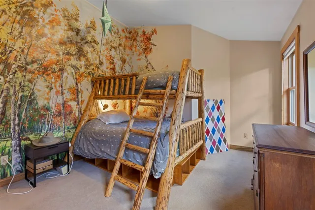 a bed room with a bed and a chair