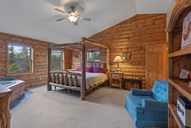 a bedroom with furniture and a chandelier