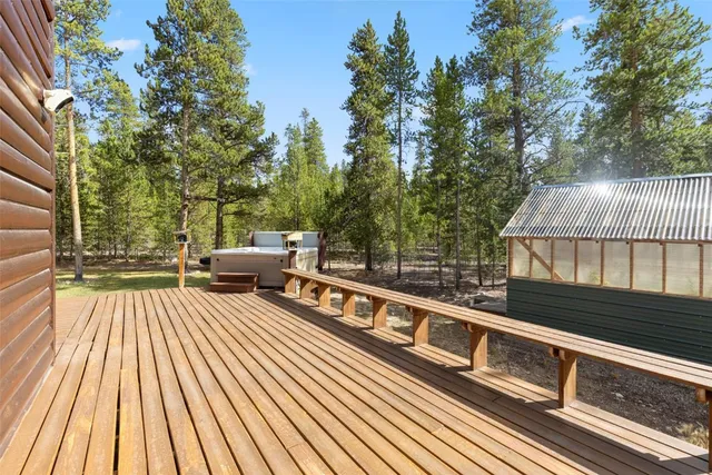 a view of a balcony with wooden floor and fence