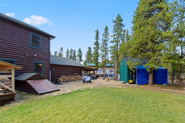 a view of a chairs and table in the backyard