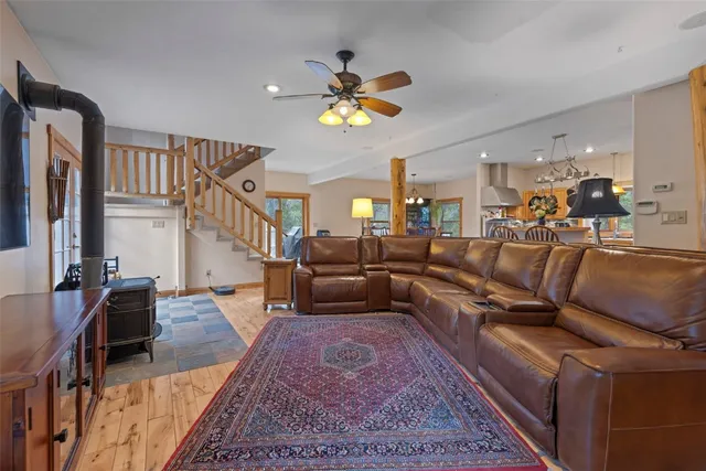a living room with furniture a chandelier and a rug