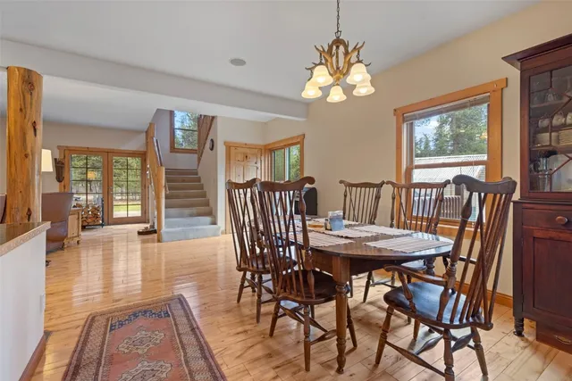 a view of a dining room with furniture wooden floor and chandelier