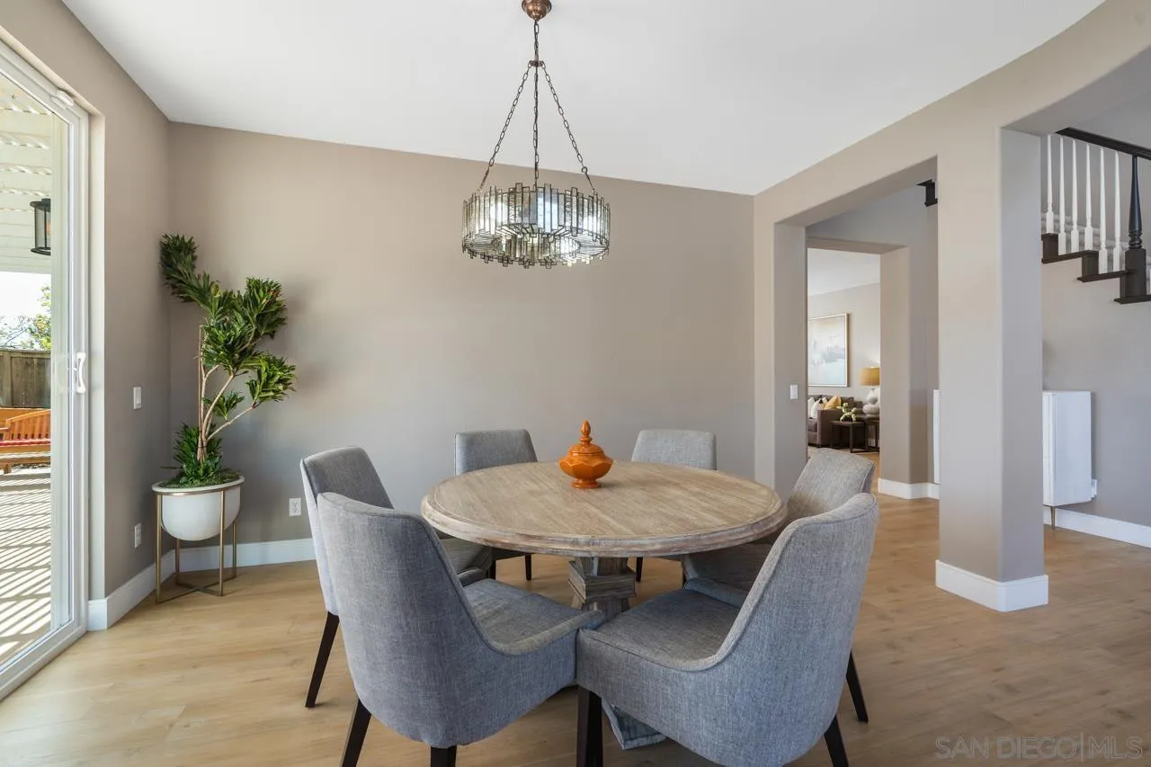 930 Merced River Road Chula Vista, CA 91913 - Photo 12 of 67 a dining room with furniture potted plants and wooden floor