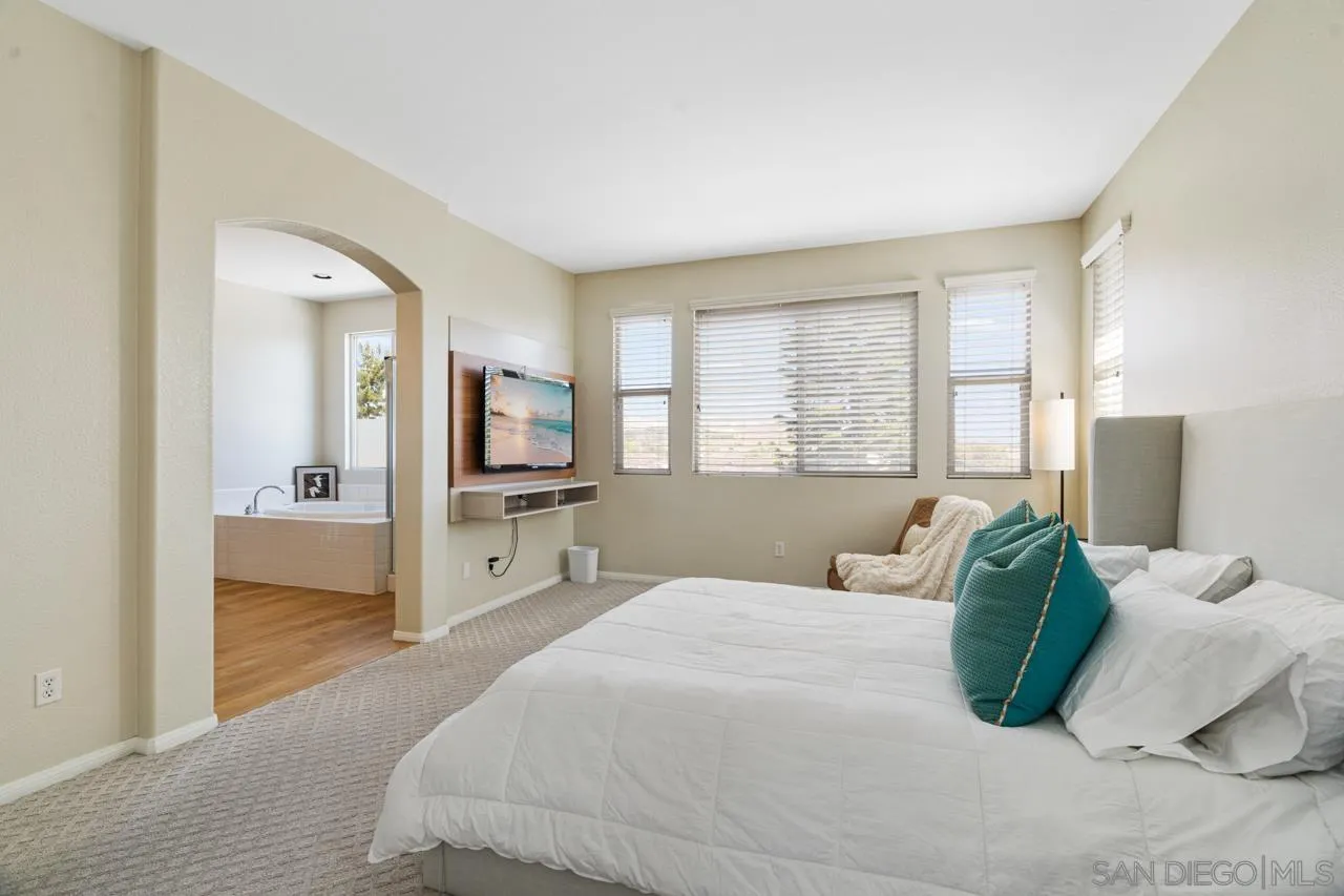 930 Merced River Road Chula Vista, CA 91913 - Photo 35 of 67 a bedroom with a large bed and a view of living room
