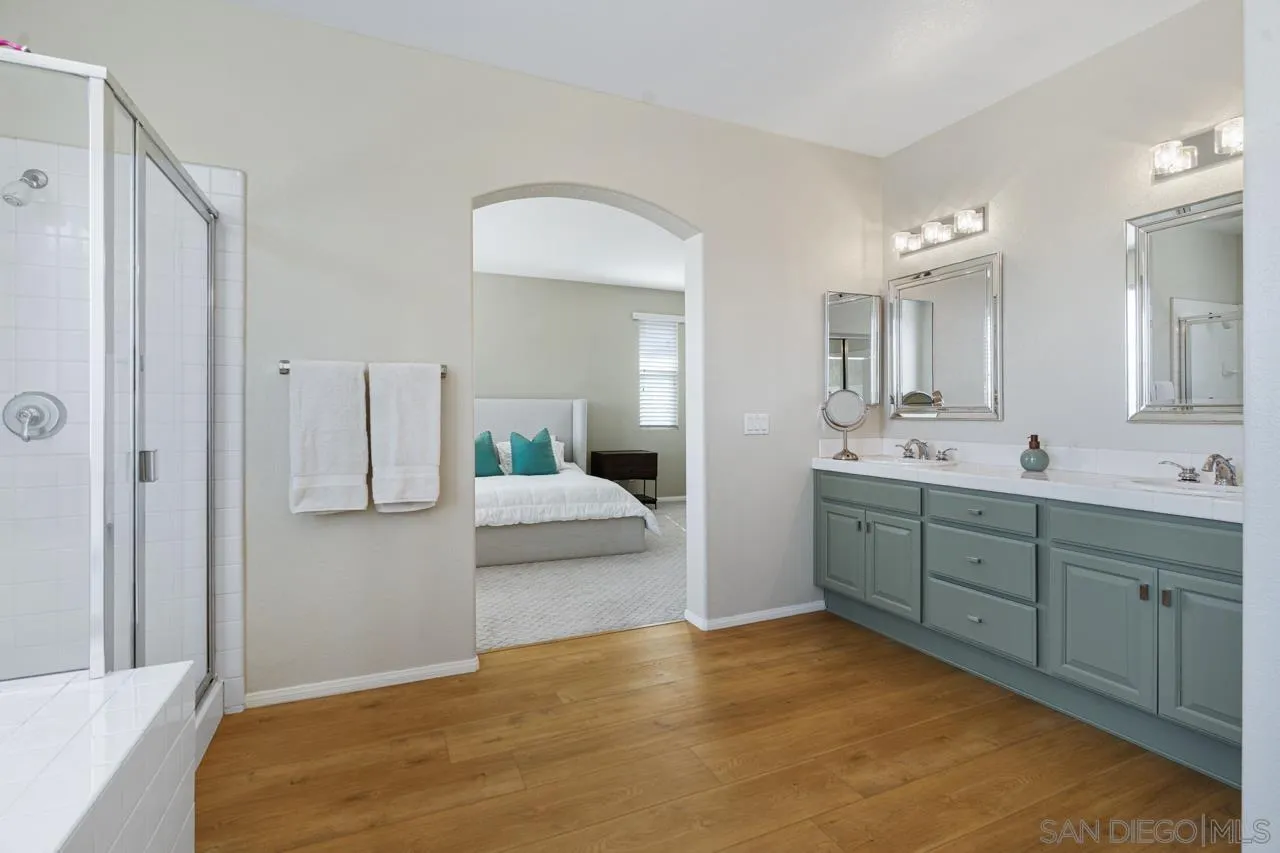 930 Merced River Road Chula Vista, CA 91913 - Photo 38 of 67 a en suite bathroom with a double vanity sink and a mirror