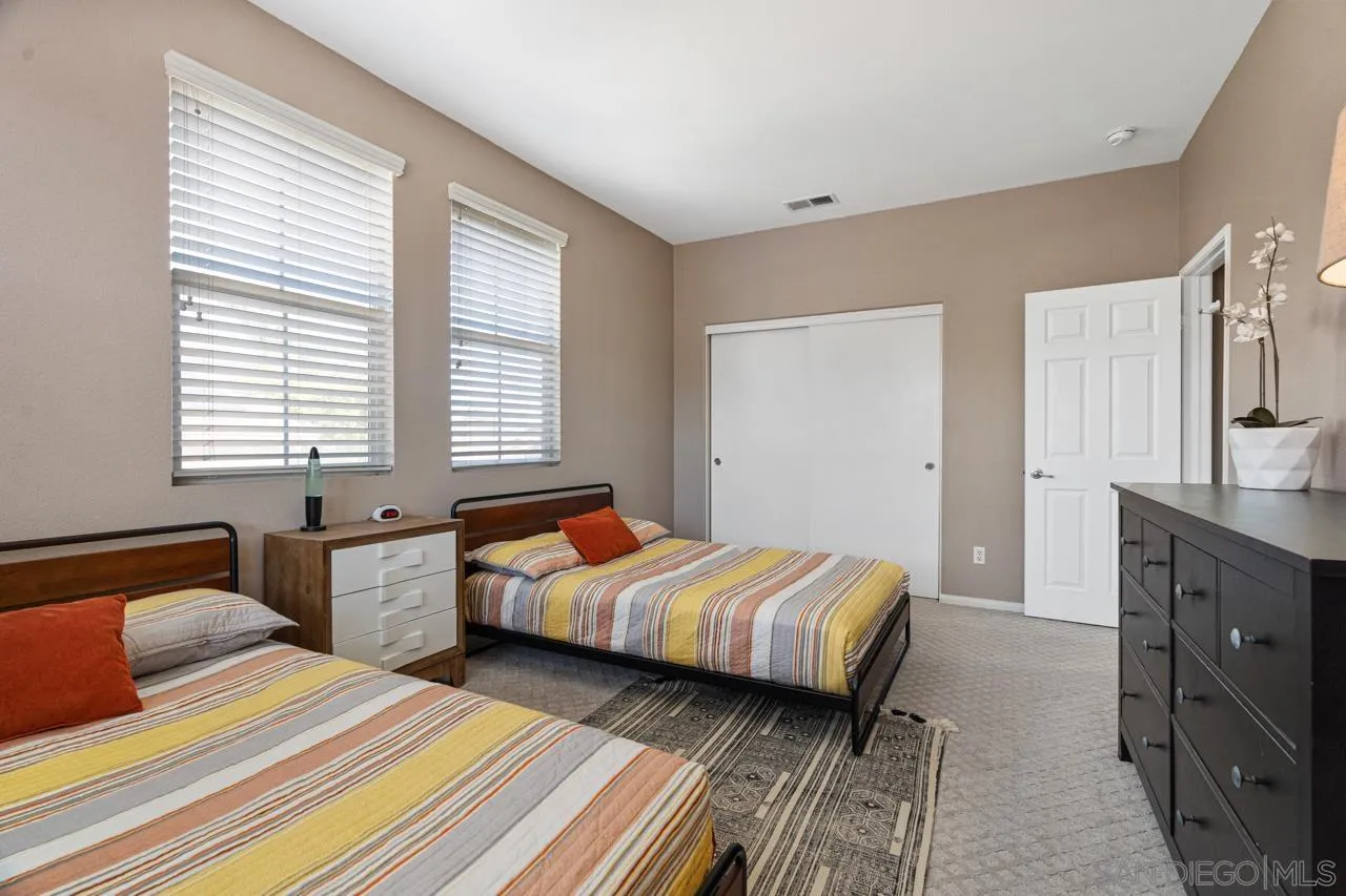 930 Merced River Road Chula Vista, CA 91913 - Photo 43 of 67 a bedroom with two beds and a dresser