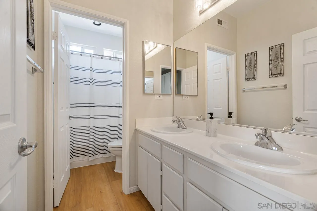 930 Merced River Road Chula Vista, CA 91913 - Photo 44 of 67 a bathroom with a double vanity sink a mirror and a shower