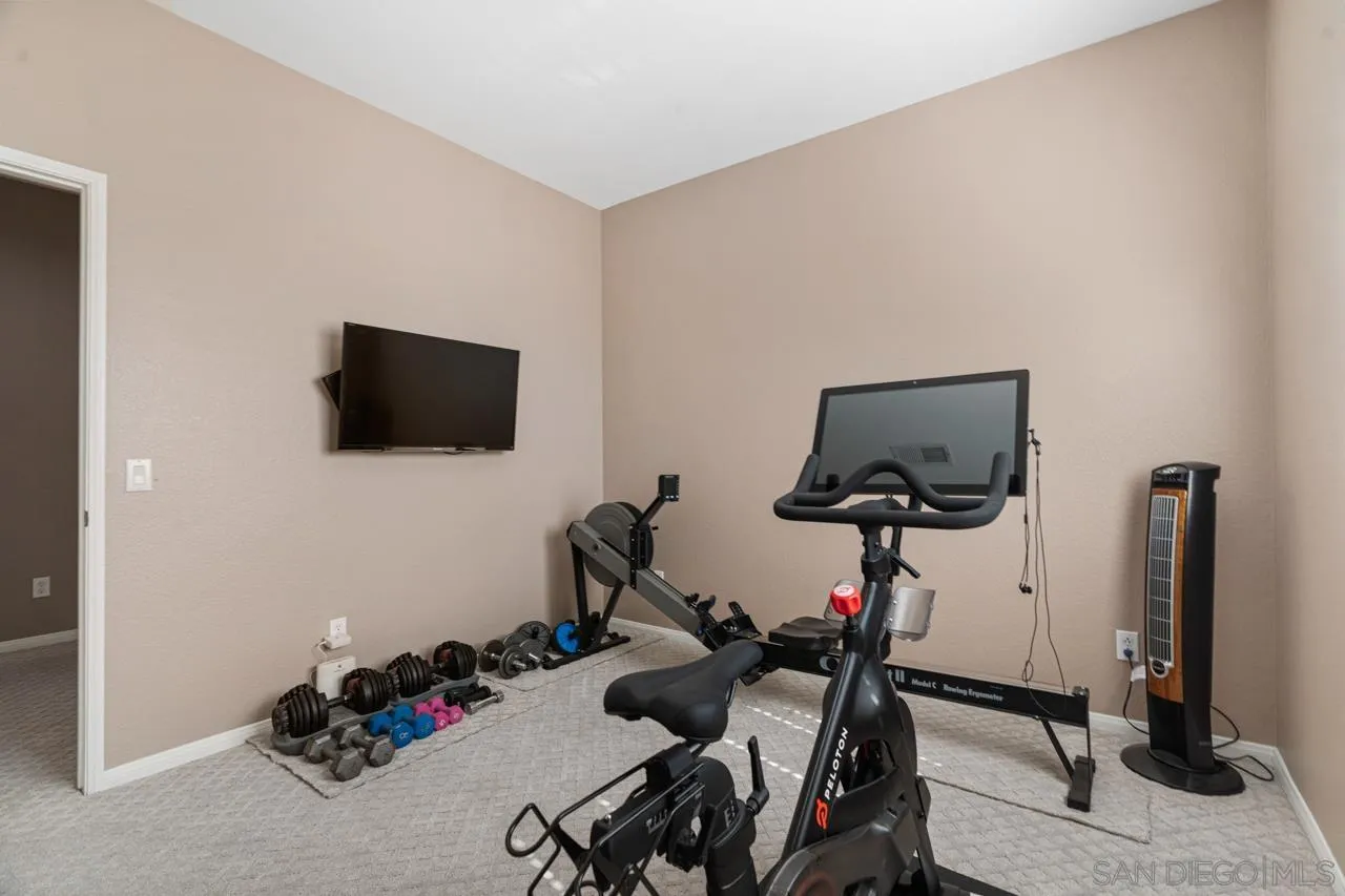 930 Merced River Road Chula Vista, CA 91913 - Photo 47 of 67 a room with gym equipment and a flat screen tv
