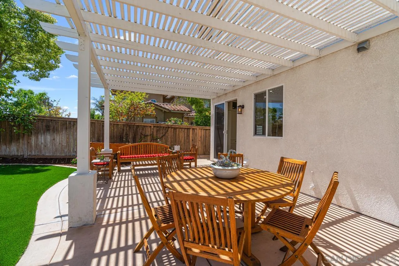 930 Merced River Road Chula Vista, CA 91913 - Photo 57 of 67 a view of a patio with table and chairs with wooden floor and fence