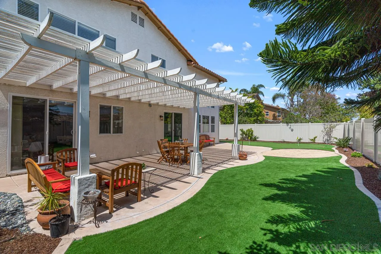 930 Merced River Road Chula Vista, CA 91913 - Photo 58 of 67 a view of a backyard with a patio table and chairs
