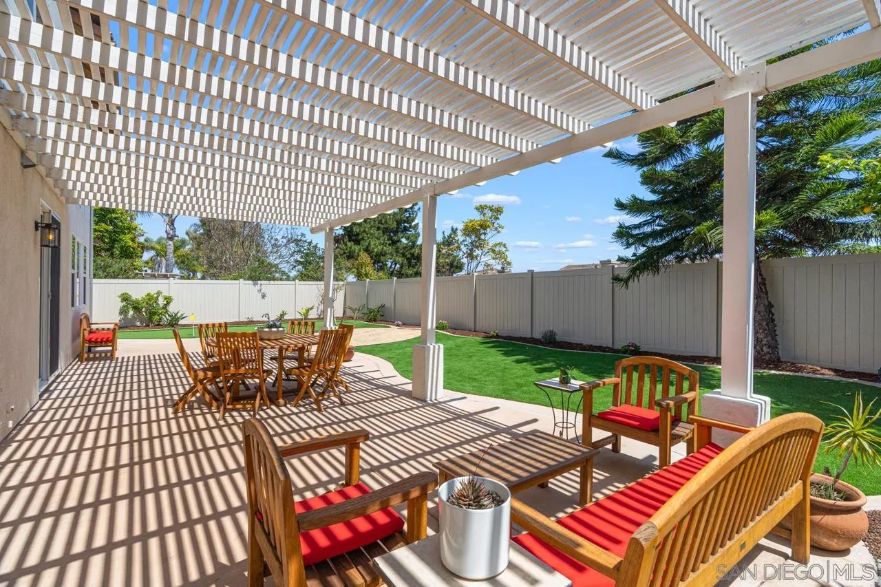930 Merced River Road Chula Vista, CA 91913 - Photo 59 of 67 a view of a patio with table and chairs potted plants with wooden floor