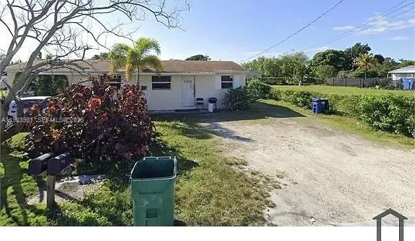 a view of a house with yard and a garden