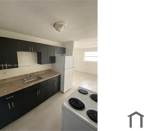 a kitchen with a stove and a refrigerator