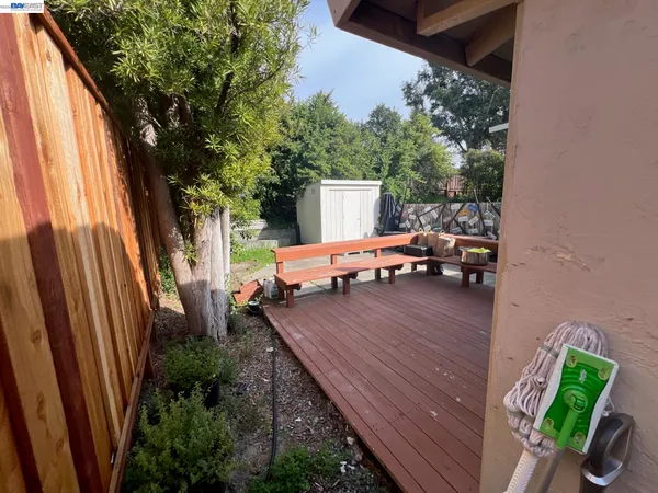 a backyard of a house with wooden floor and outdoor seating