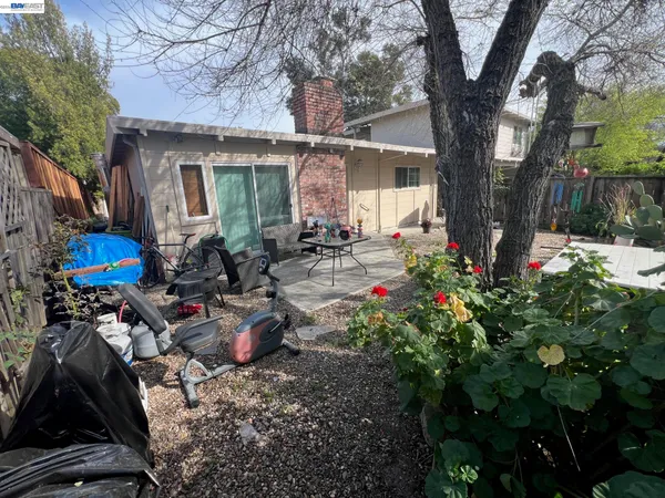 a view of a house with sitting area and garden