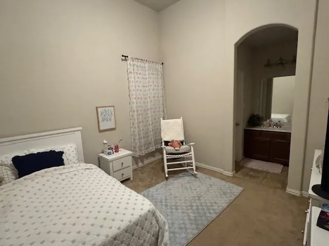 a bedroom with a bed and a desk