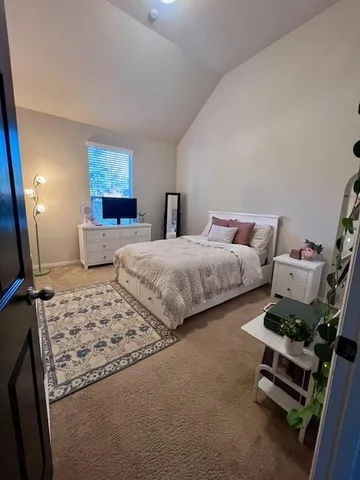 a bedroom with bed and a flat screen tv