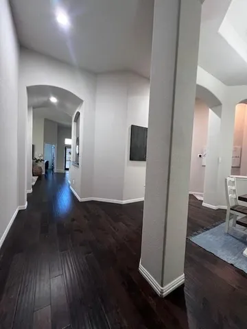 a view of a hallway with wooden floor